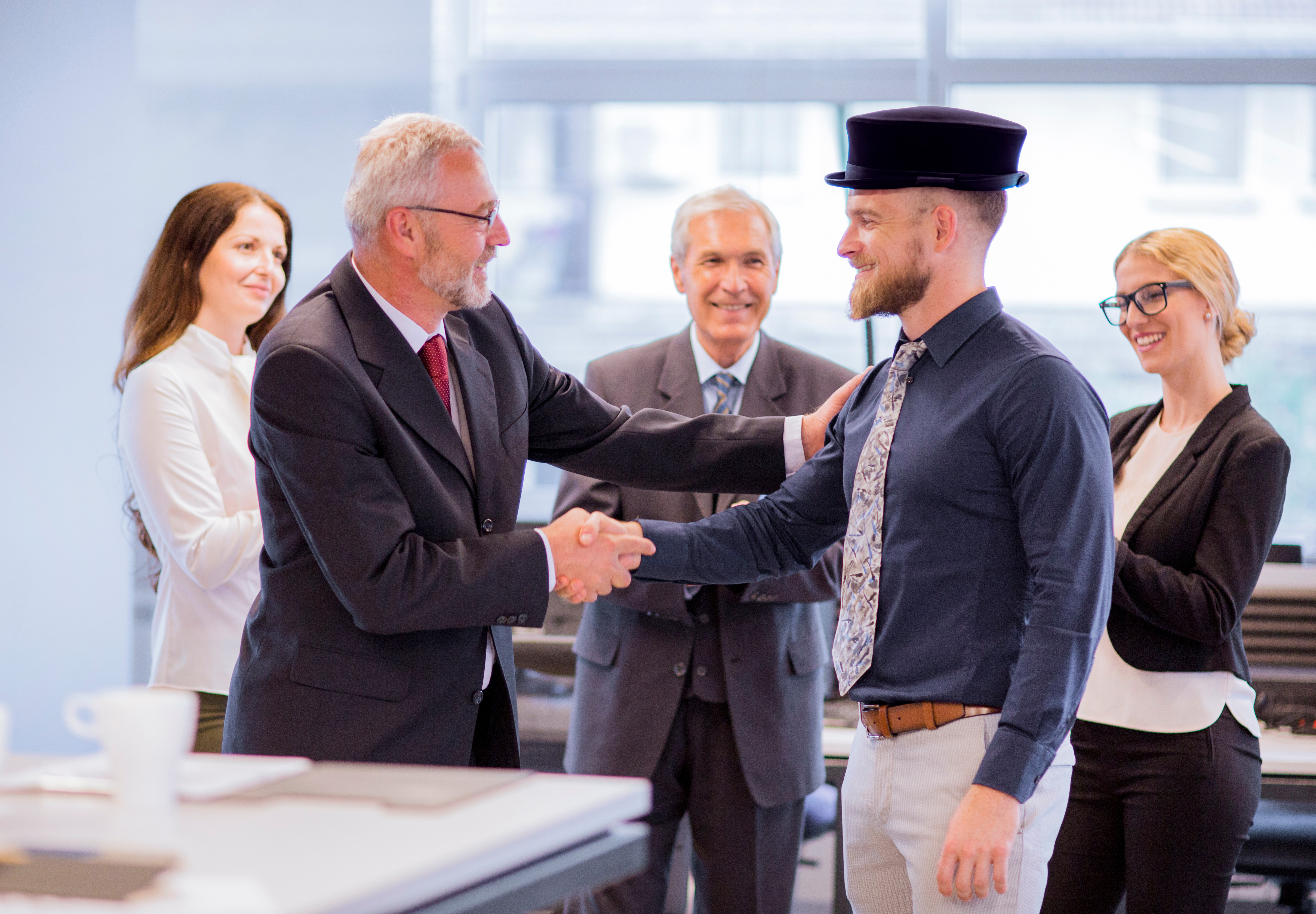 two-businessmen-shaking-hands-congratulating-promotion